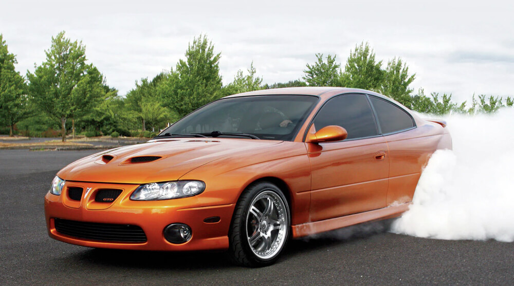 Orange Pontiac GTO Doing a Burnout