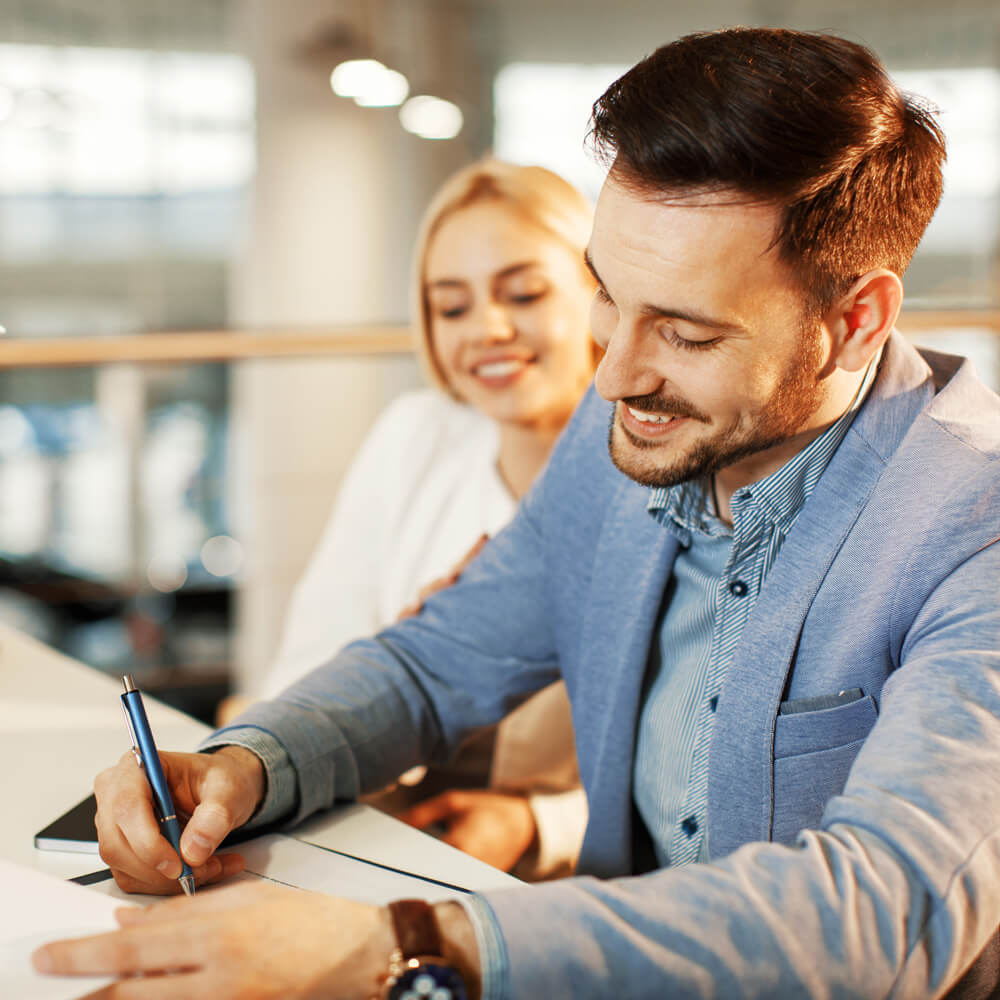 Couple signing papers for new auto loan