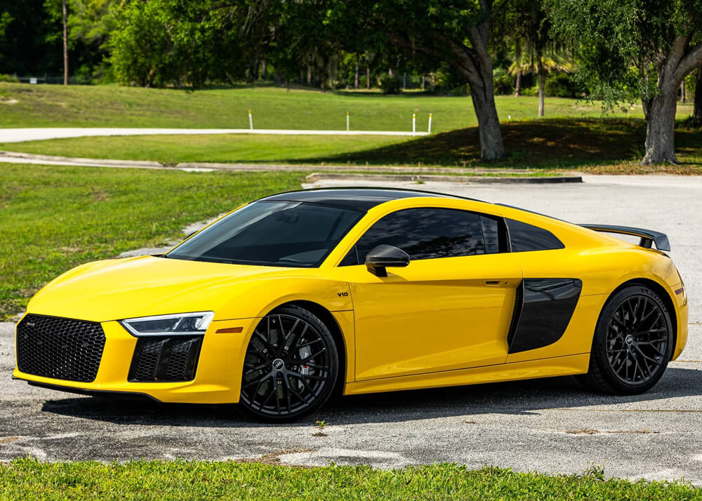 Yellow Audi R8 V10 Plus parked in grass