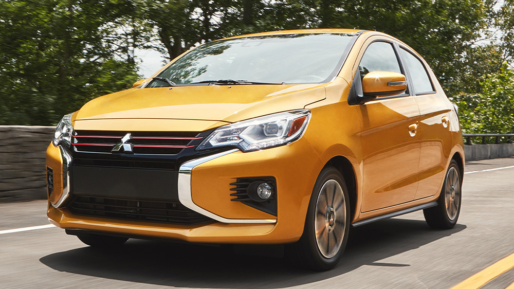 Golden Yellow 2023 Mitsubishi Mirage driving down street