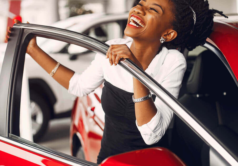 Ebony lady happy after buying a car at a great price