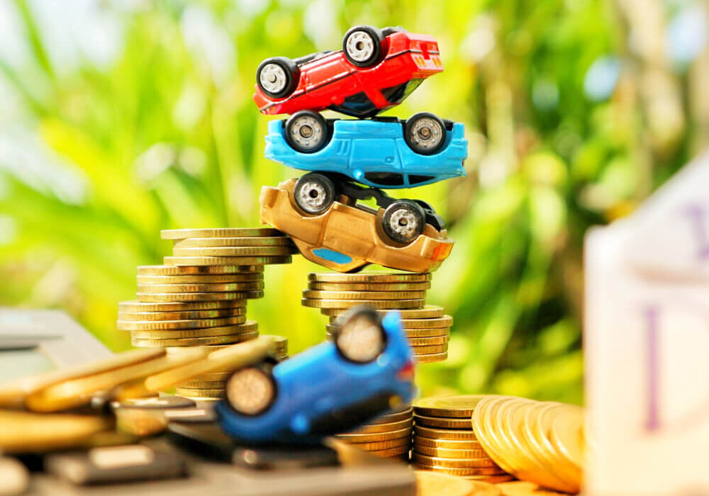 Toy car upside down on coins